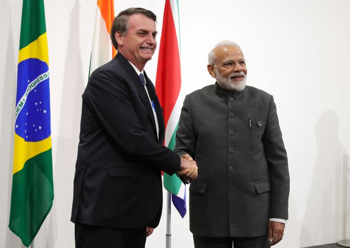 Brazilian President Jair Bolsonaro (L) shakes hands with India's Prime Minister Narendra Modi during a BRICS summit meeting at the G20 summit in Osaka on June 28, 2019. 