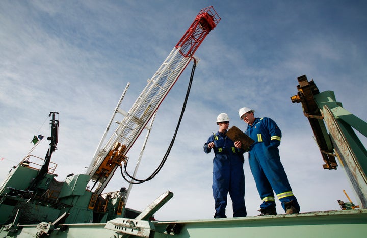 Encana employees at a gas drilling well east of Calgary, Alta., Feb. 15, 2007.