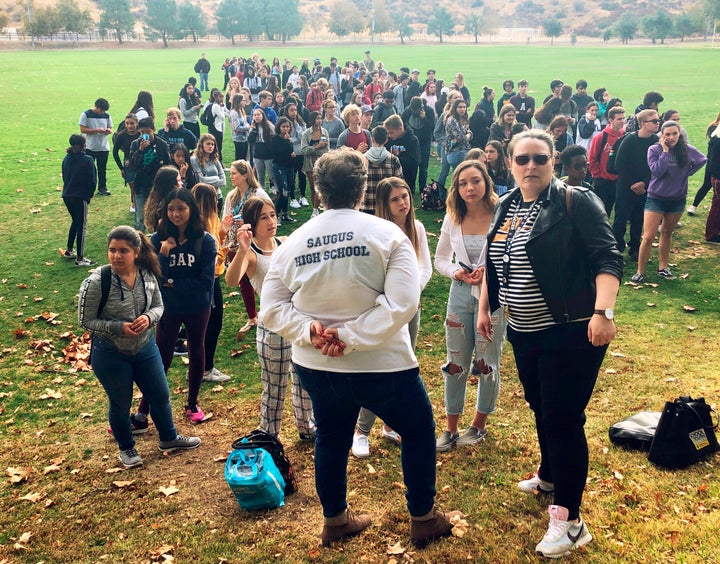 Students and others wait outside a reunification center after the shooting Thursday.