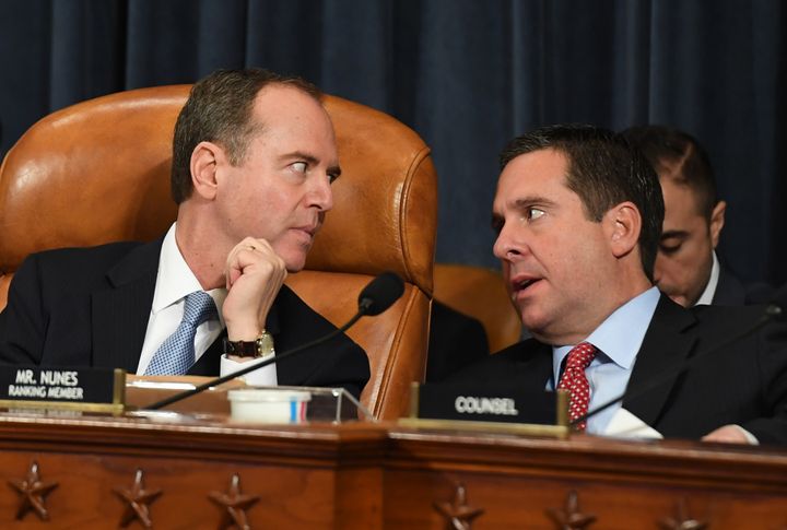 House Intelligence Committee Chairman Adam Schiff (D-Calif.), left, talks with ranking member Rep. Devin Nunes (R-Calif.) on the first day of public impeachment inquiry testimony on Wednesday.