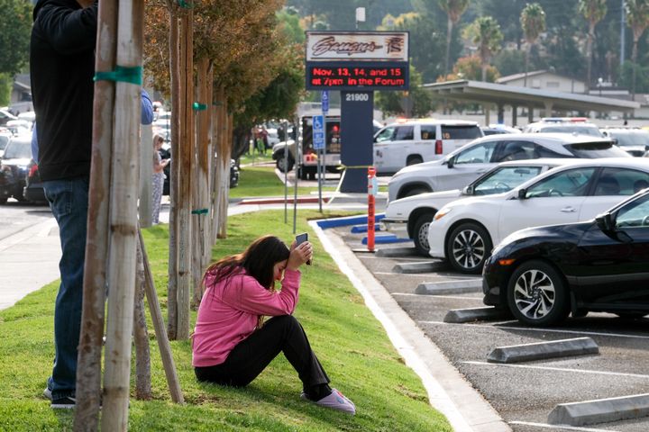 A parent waits outside of Saugus High School in Santa Clarita, California, on Thursday, after an active shooter was reported at the school about 7:30 a.m.