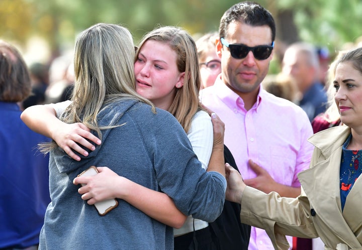 Students and parents embrace after being picked up at Central Park, after a shooting at Saugus High School.