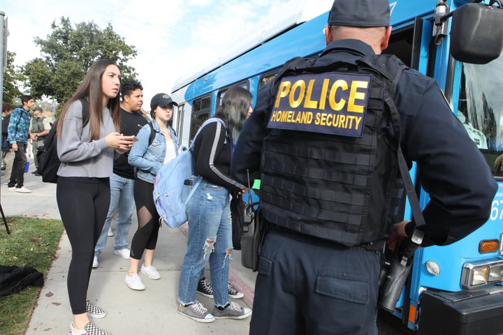 Students are evacuated from Saugus High School onto a bus after a shooting at the school left two students dead and three wounded.