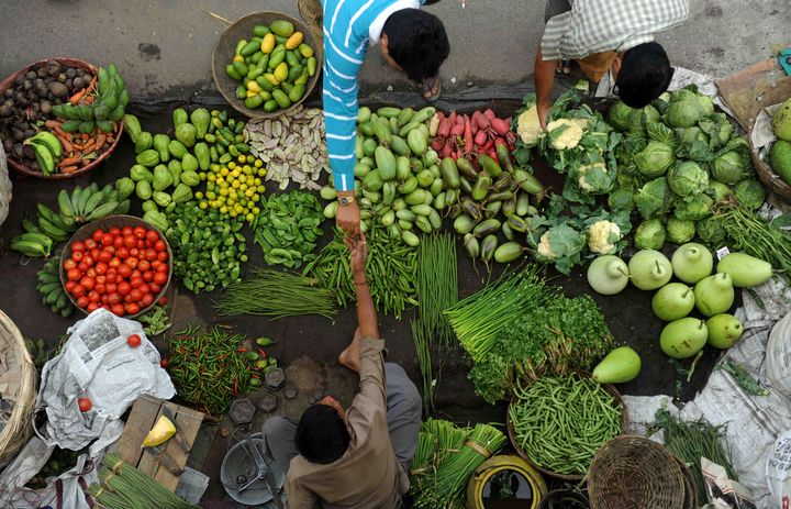 A customer purchases vegetables at a roadside market.