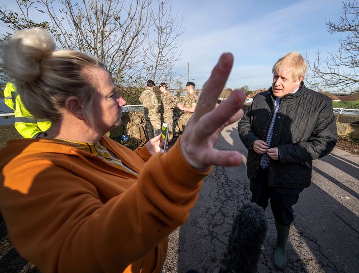 Britain's Prime Minister Boris Johnson, right, talks to a local resident, during a visit to see the effects of recent flooding, in Stainforth, England, Wednesday, Nov. 13, 2019. (Danny Lawson/Pool Photo via AP)