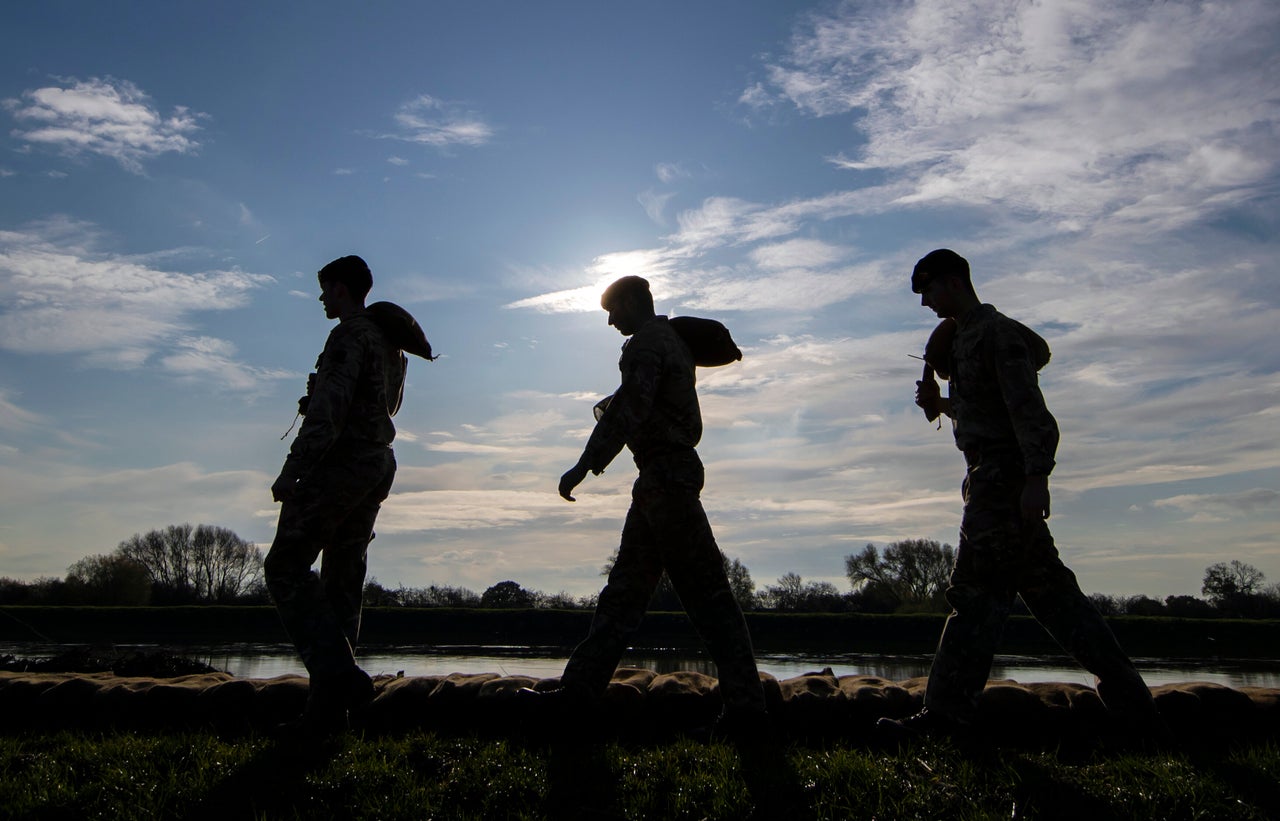 Soldiers carry sandbags along an embankment at Stainforth, near Doncaster, after a visit by the Prime Minister.