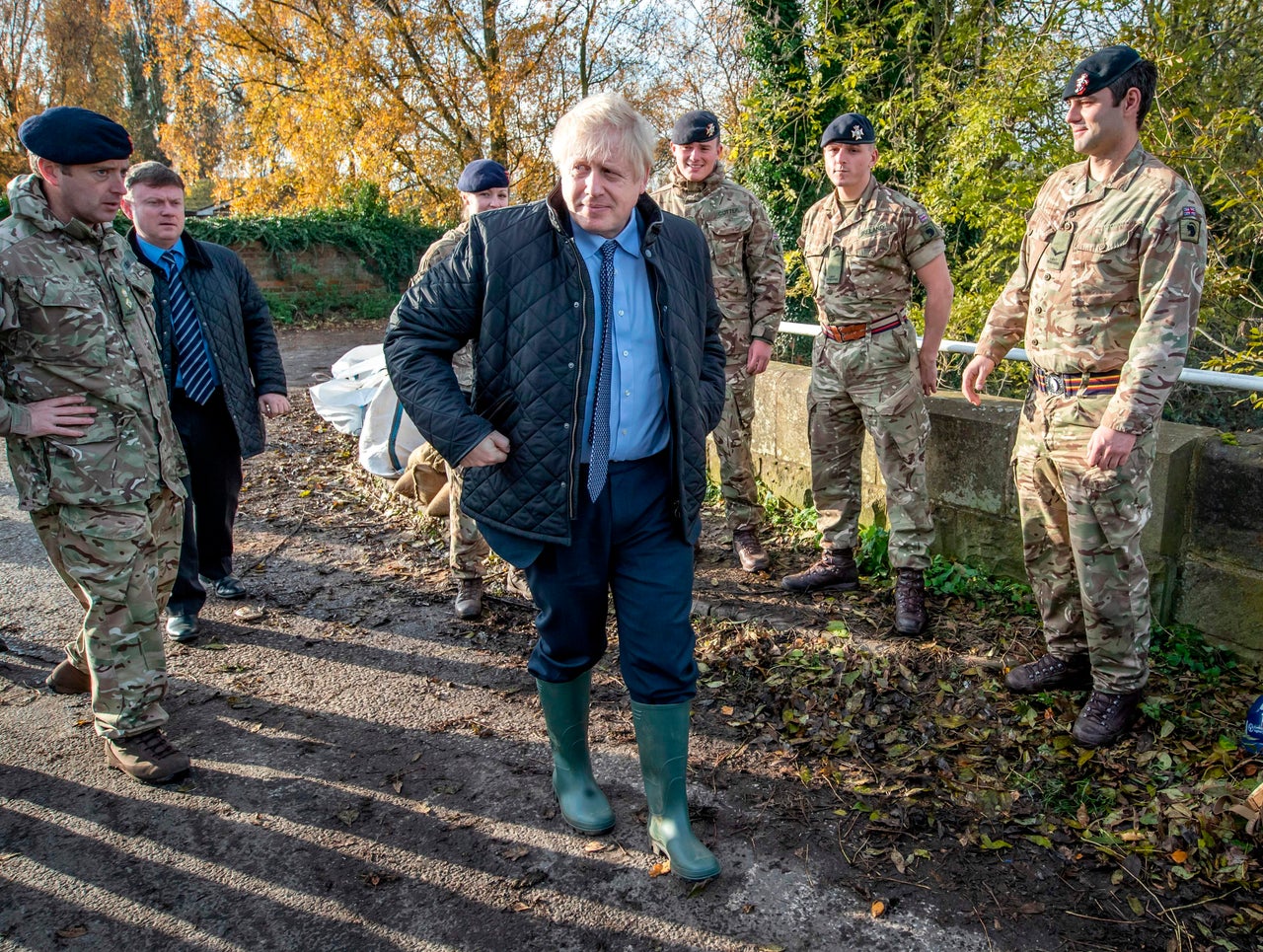 Britain's Prime Minister Boris Johnson walks past members of the Light Dragoons during a visit to Stainforth, near Doncaster, on Wednesday.