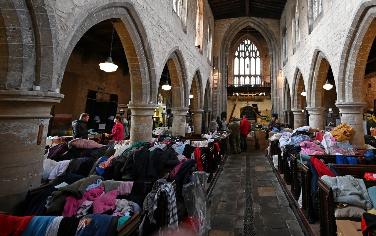 Volunteers work to help distribute donated provisions and aid for flood affected residents, inside Fishlake St. Cuthbert church on Wednesday.