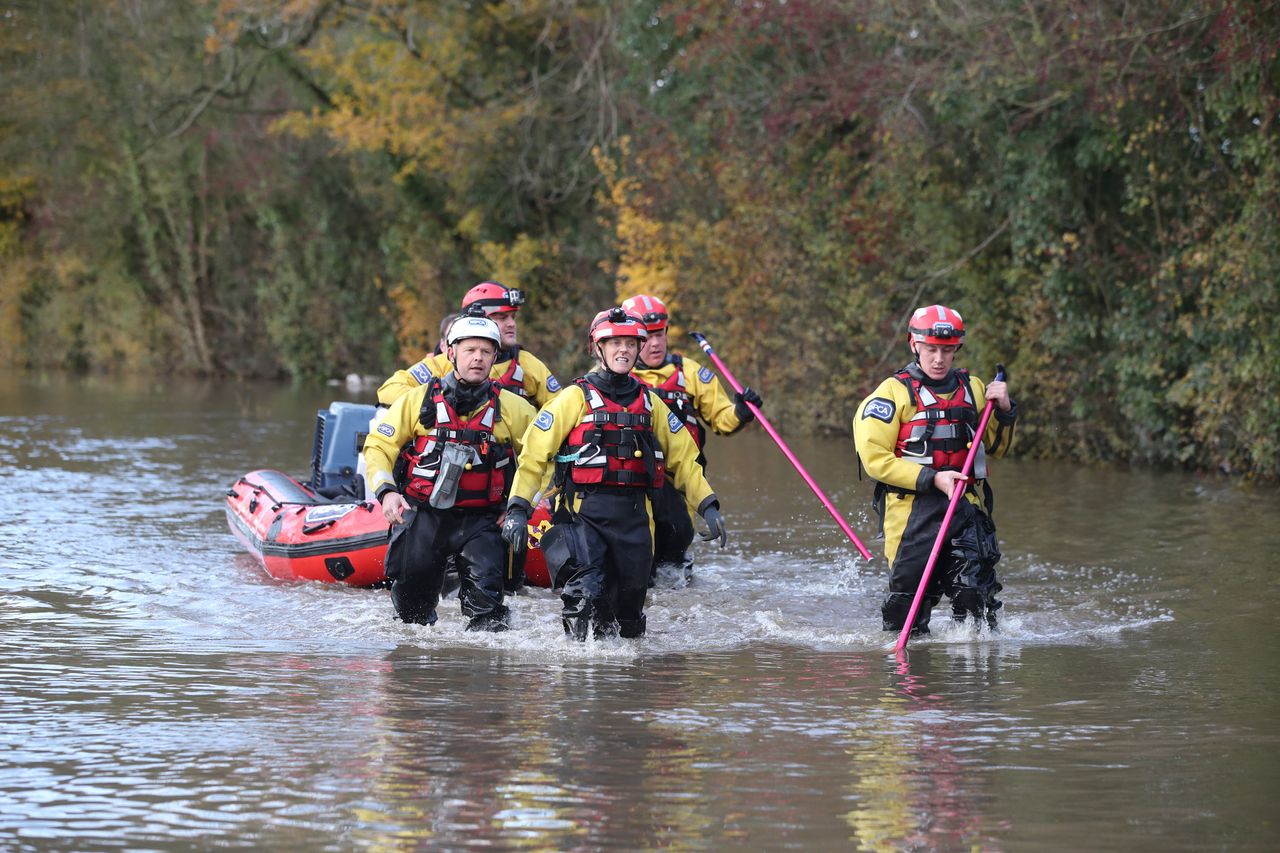 Rescuers pull a boat through floodwater in Fishlake, Doncaster.