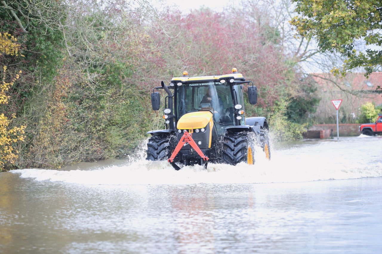 A tractor drives through floodwater in Fishlake, Doncaster.