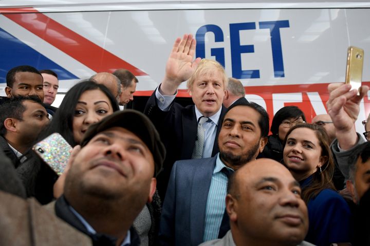 Prime Minister Boris Johnson is surrounded by supporters at the unveiling of the Conservative Party battlebus in Middleton, Greater Manchester.