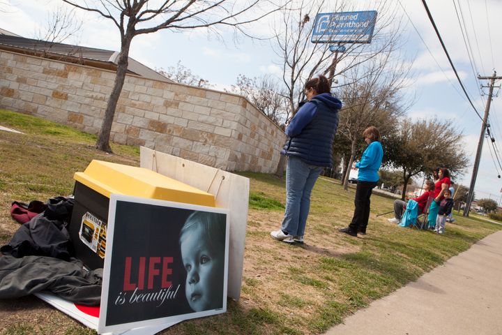Anti-abortion activists pray outside a Planned Parenthood clinic that offers abortions, on February 22, 2016 in Austin, Texas