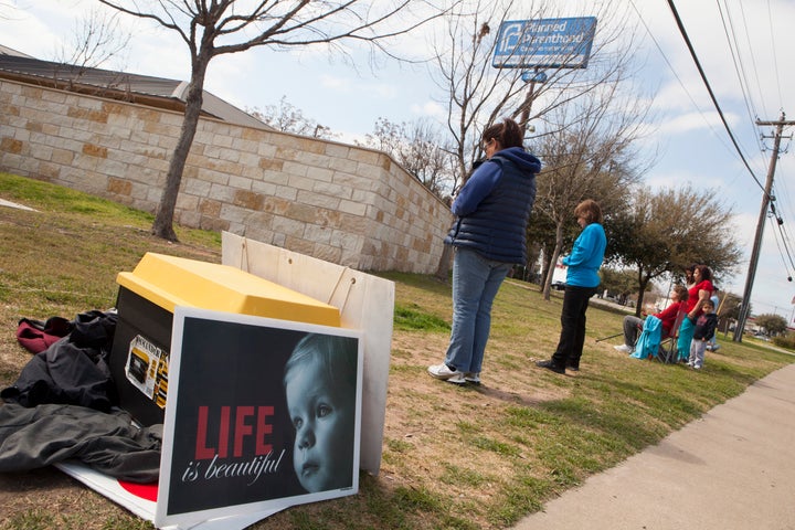 Anti-abortion activists pray outside a Planned Parenthood clinic that offers abortions, on February 22, 2016 in Austin, Texas. 