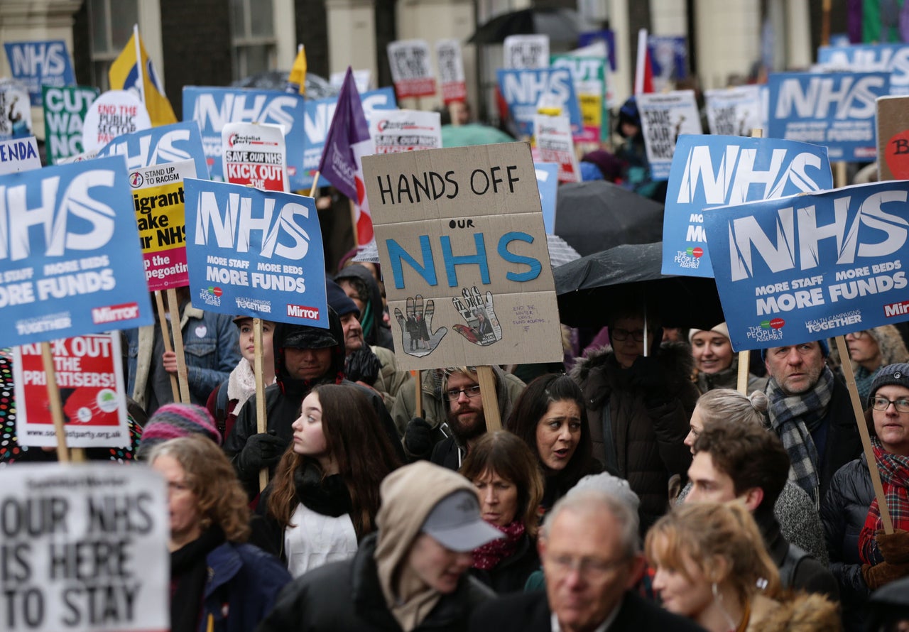 People take part in a march in London in support of the National Health Service to demand an end to the "crisis" in the NHS.