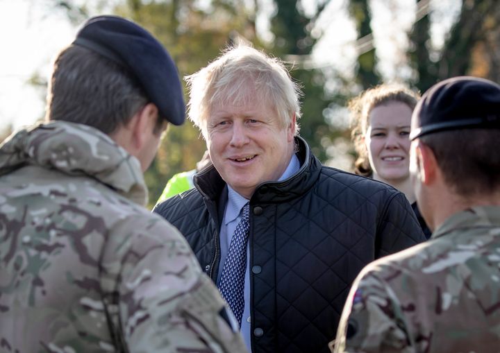 Prime Minister Boris Johnson chats soldiers during a visit to Stainforth, Doncaster, to see the recent flooding.