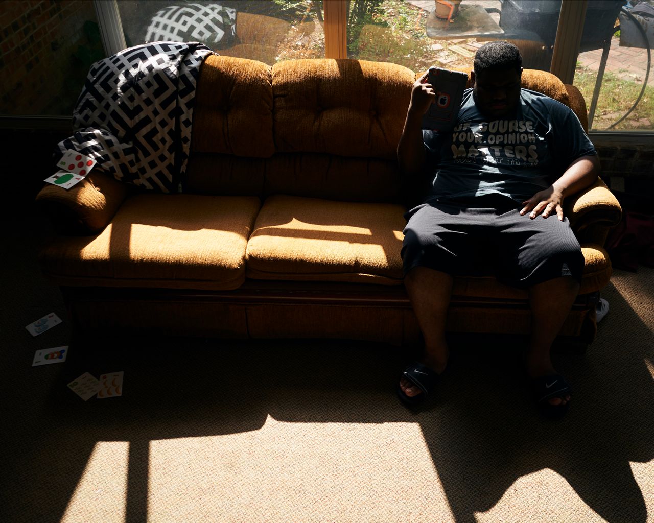 J.H. listens to music on his iPad in the sunroom at his home in Shreveport, Louisiana, on Aug. 25, 2019.