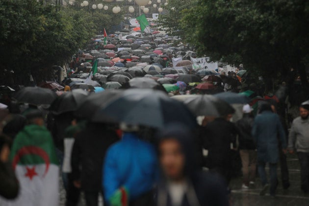 Algerian demonstrators take to the streets in the capital Algiers to protest against the government and...