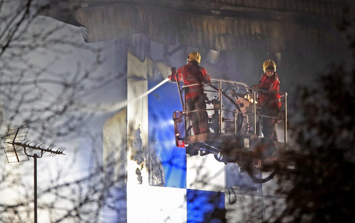 Firefighters at the scene after a fire on the top floors of a building on Bradshawgate in Bolton.