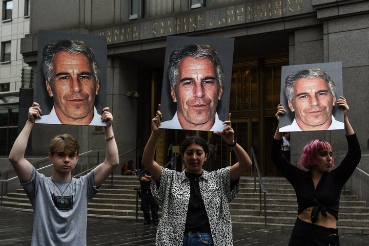 A protest group called "Hot Mess" hold up signs of Jeffrey Epstein in front of the Federal courthouse on July 8, 2019 in New York City.