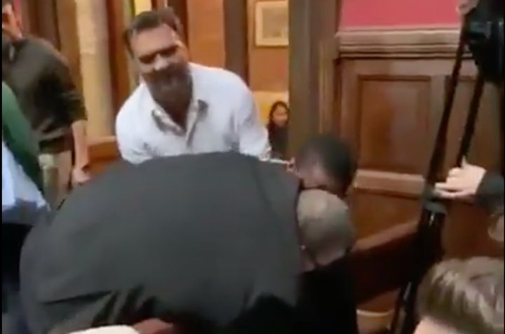 Video footage shows Azamati being "dragged" from the room. 