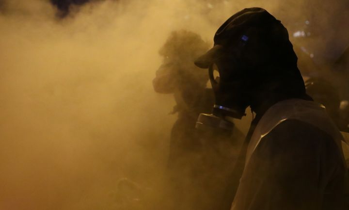 Anti-government protesters stand amid smoke during clashes with police, outside Hong Kong Polytechnic University (PolyU) in Hong Kong, China on November 17, 2019. (REUTERS/Athit Perawongmetha)
