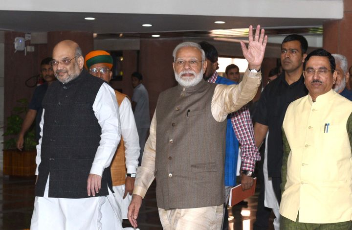 Prime Minister Narendra Modi waves as he, along with Home Minister Amit Shah, Union Parliamentary Affairs Minister Pralhad Joshi and other leaders leave after attending the all-party meeting ahead of the winter session of Parliament on November 17, 2019 in New Delhi.