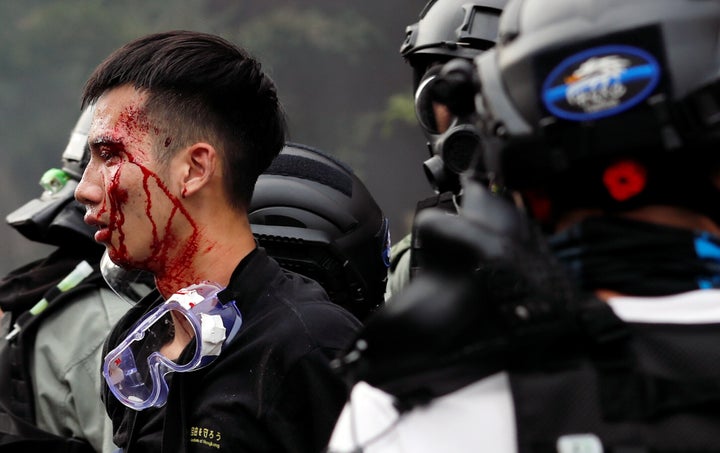 Police detain protesters who attempt to leave the campus of Hong Kong Polytechnic University (PolyU) during clashes with police in Hong Kong, China November 18, 2019. REUTERS/Tyrone Siu