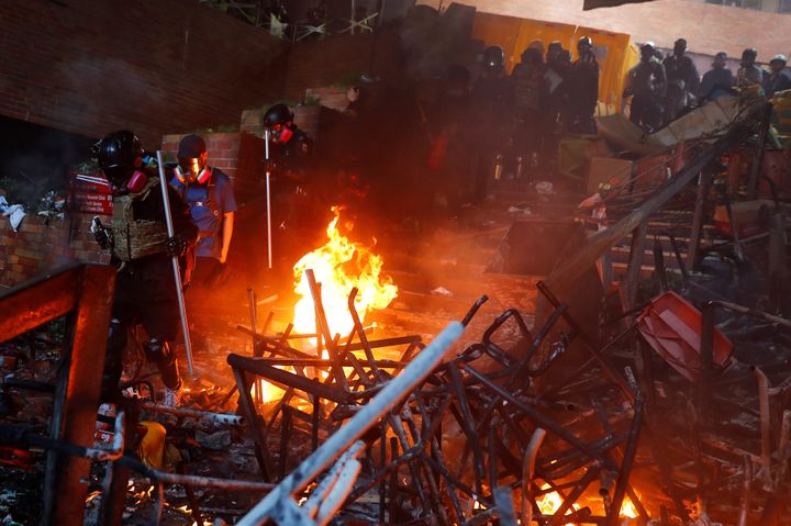 Police storm the burning barricade at the Hong Kong Polytechnic University (PolyU).