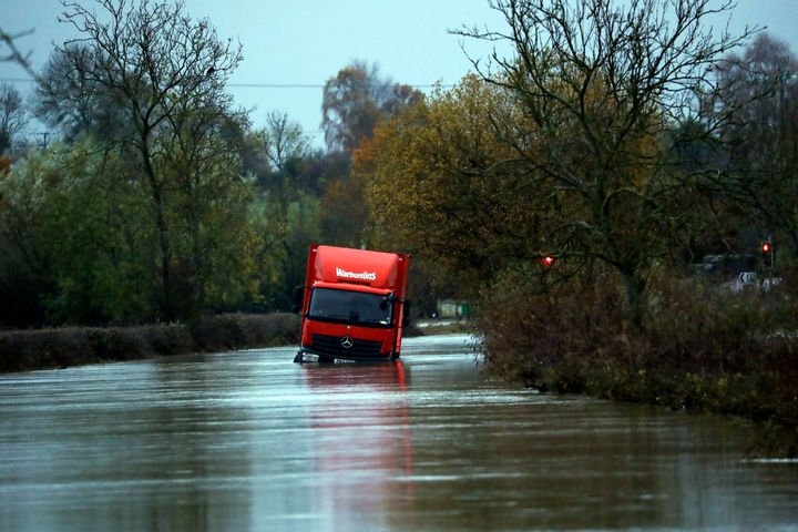 A lorry is stranded on a flooded road near Eckington, Derbyshire, as temperatures are expected to plummet in some areas affected by the floods. 