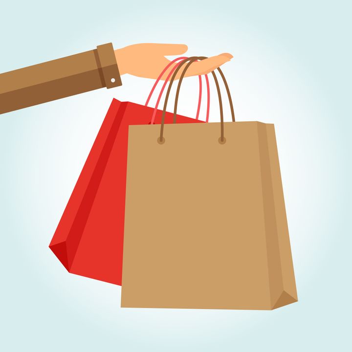 Hand holding two papper bags shopping. Vector illustration.