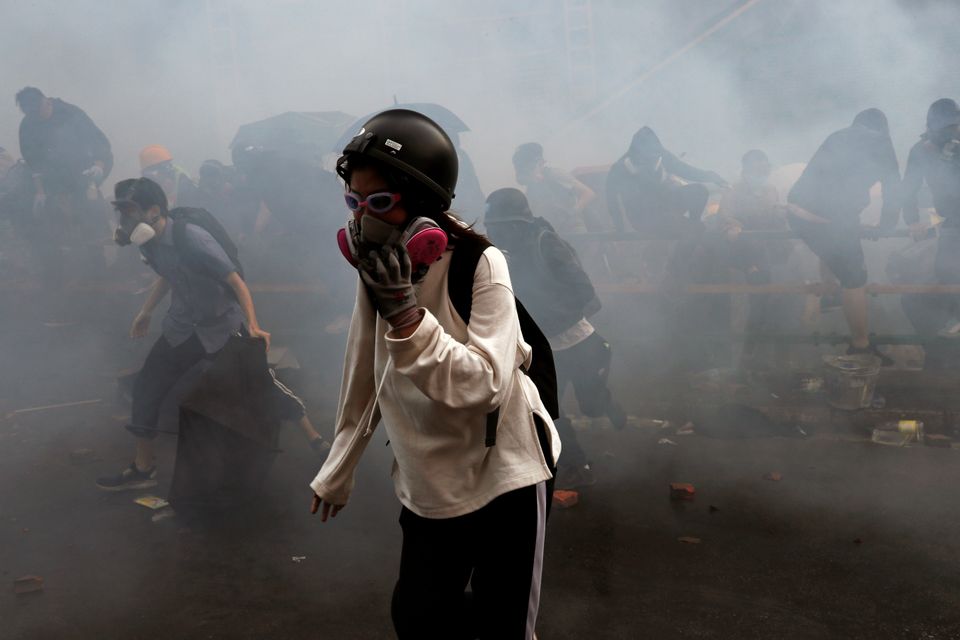 Protesters attempt to escape from tear gas while trying to leave the Polytechnic University campus on Monday