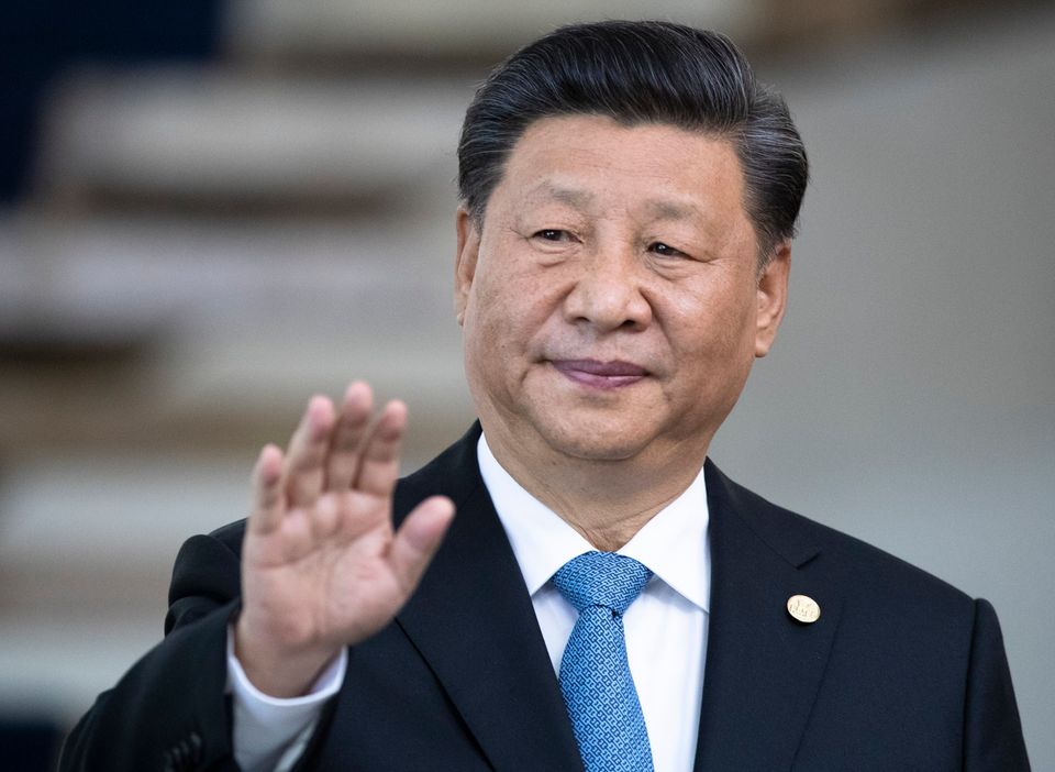 China's President Xi Jinping greets the media prior to a meeting of leaders of the BRICS emerging economies at the Itamaraty palace in Brasilia, Brazil, Thursday, Nov. 14, 2019. (AP Photo/Pavel Golovkin, Pool)