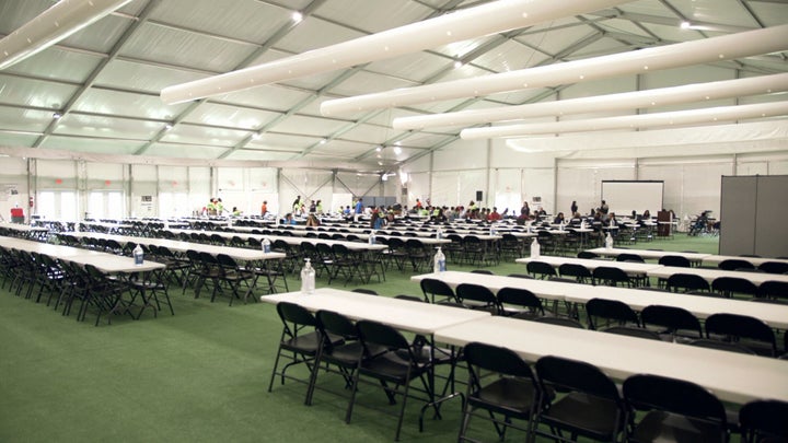 Children use the cafeteria at the U.S. Department of Health and Human Services' unaccompanied minors migrant detention facili