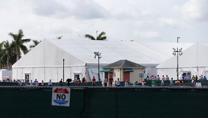 Migrant children who have been separated from their families can be seen in tents at a detention center in Homestead, Florida