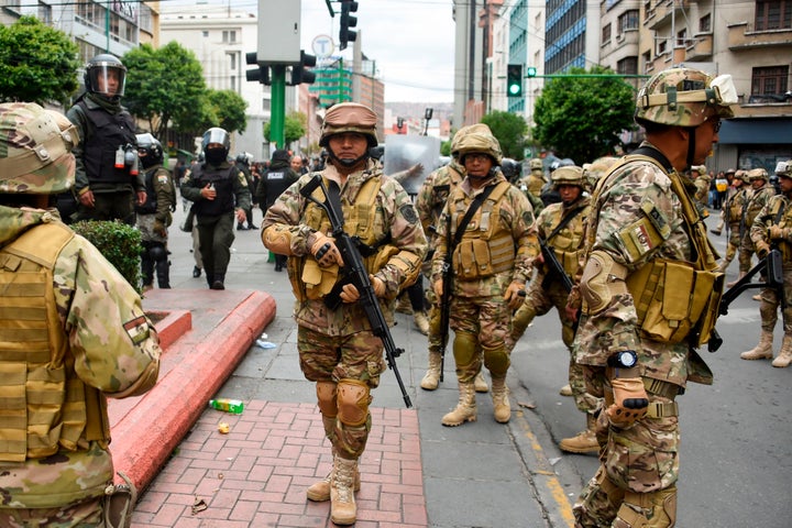 Militarized Bolivian police stand guard as supporters of Evo Morales demonstrate in La Paz on Nov.14, 2019.