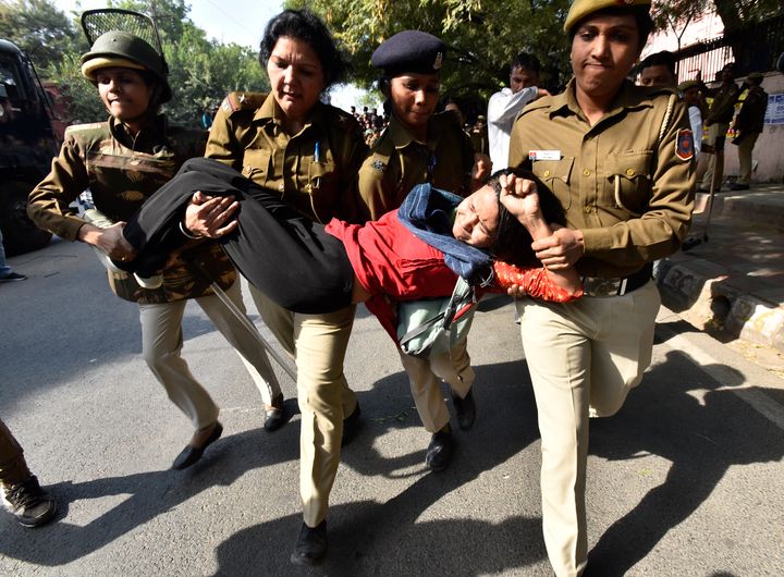 Police detain a student during a protest by the students of JNU against hostel fee hike, near JNU Campus on November 18, 2019 in New Delhi.