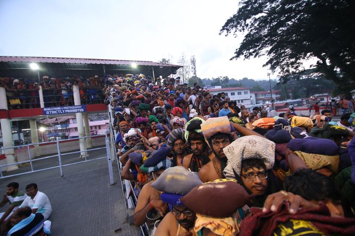 Devotees stand in line at the Sabarimala temple to pray at the shrine.