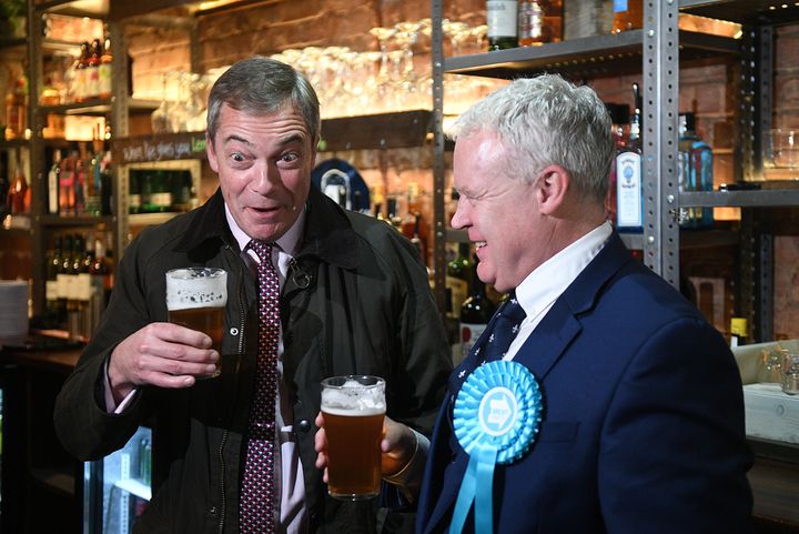 Brexit Party leader Nigel Farage and Peterborough candidate Mike Greene enjoy a pint in the Queen's Head pub during a walkabout in the three-way marginal seat