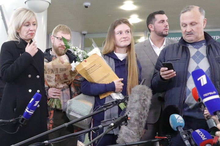 Russian citizen Maria Butina (center) is seen with her father Valery Butin (right) while talking to reporters in Russia following her deportation.