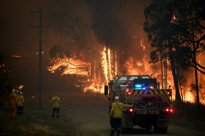 NSW Rural Fire Service crews fight a fire as it burns close to property on Wheelbarrow Ridge Road at Colo Heights, north west of Sydney on November 19, 2019. 