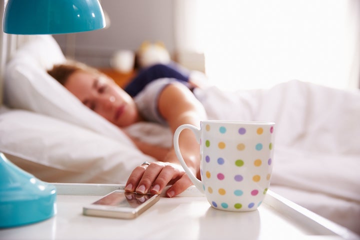 Sleeping Couple Being Woken By Mobile Phone In Bedroom