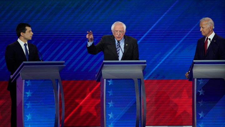 South Bend Mayor Pete Buttigieg, left, and former Vice President Joe Biden, right, listen as Sen. Bernie Sanders, I-Vt., center, speaks Thursday, Sept. 12, 2019, during a Democratic presidential primary debate hosted by ABC at Texas Southern University in Houston.