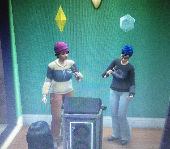 Sims version of Axi (left) and Ocean Capewell singing karaoke