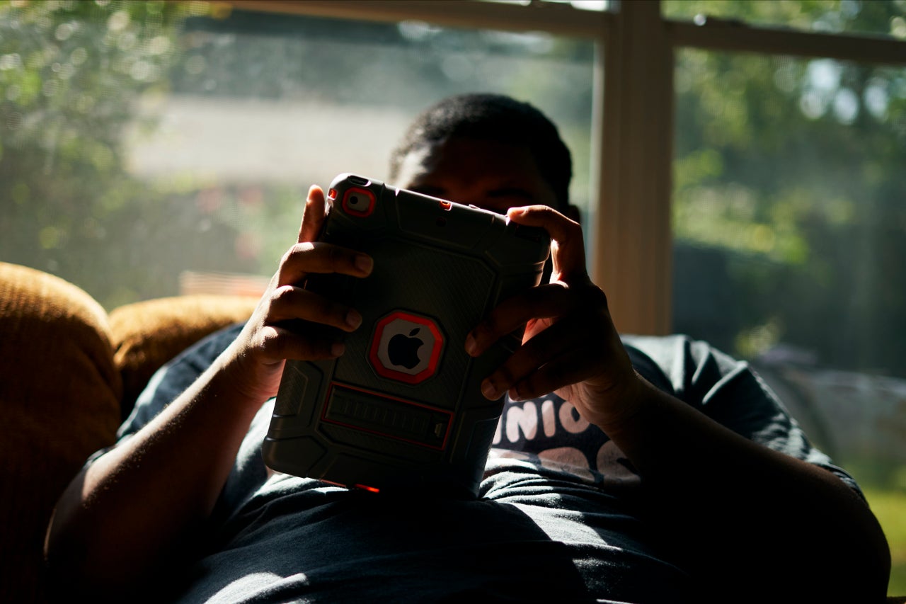 J.H. listens to music on his iPad in the sunroom at his home in Shreveport, Louisiana, on Aug. 25.