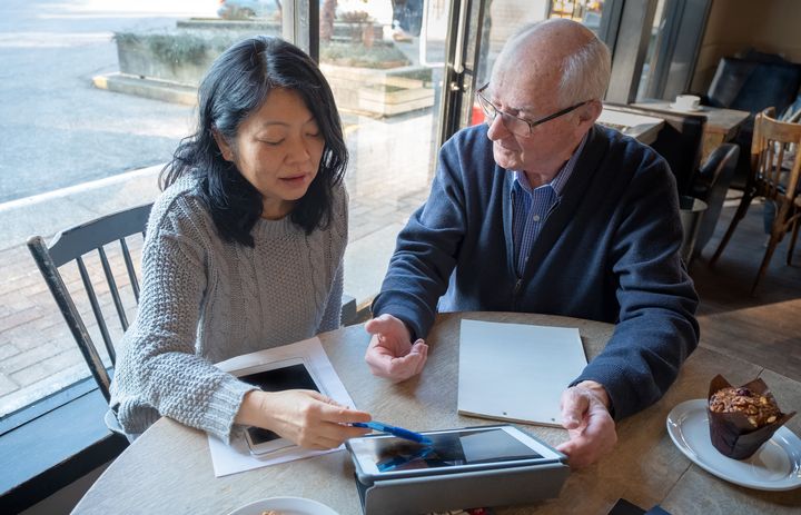 A financial expert helps an elderly man go over his personal finances in this stock photo. A survey suggests nearly half of Canadians are concerned about outliving their retirement savings.