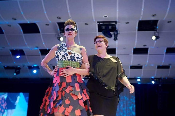 Freeze at a paper couture fashion show in 2018 with her piece highlighting soldier suicide. The model wearing the dress is also a combat veteran.