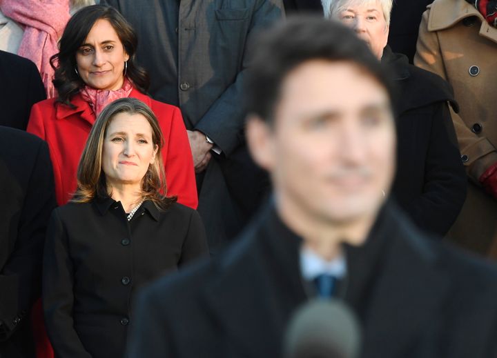 Liberal MPs Anita Anand, top left, and Chrystia Freeland look on as Prime Minister Justin Trudeau speaks following the swearing-in of the new cabinet at Rideau Hall in Ottawa on Nov. 20, 2019.