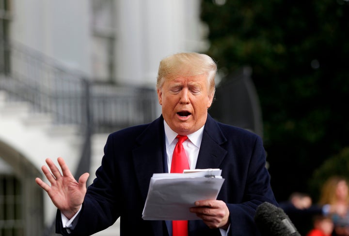 US President Donald Trump reads from his notes as he talks to the media on November 20.