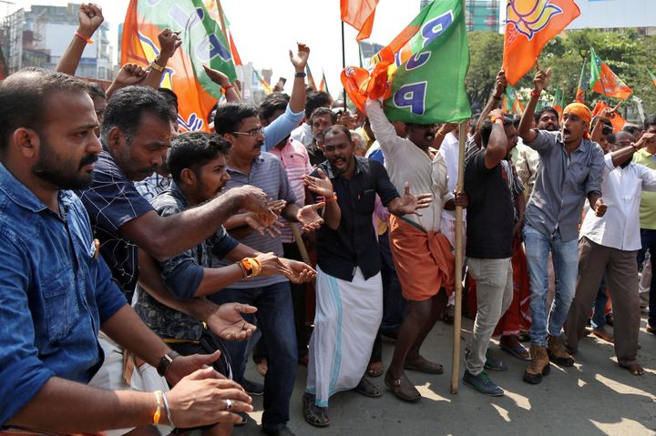 Supporters of BJP shout slogans as they block a highway during a protest against the arrest of their leader K Surendran, who police said was taken into preventive custody on Saturday night at Nilakkal base camp near the Sabarimala temple, on November 18, 2018. 
