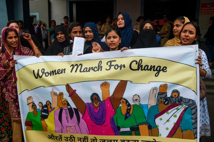 Women hold a banner during a protest against atrocities on women in Mumbai on 1 August, 2019.